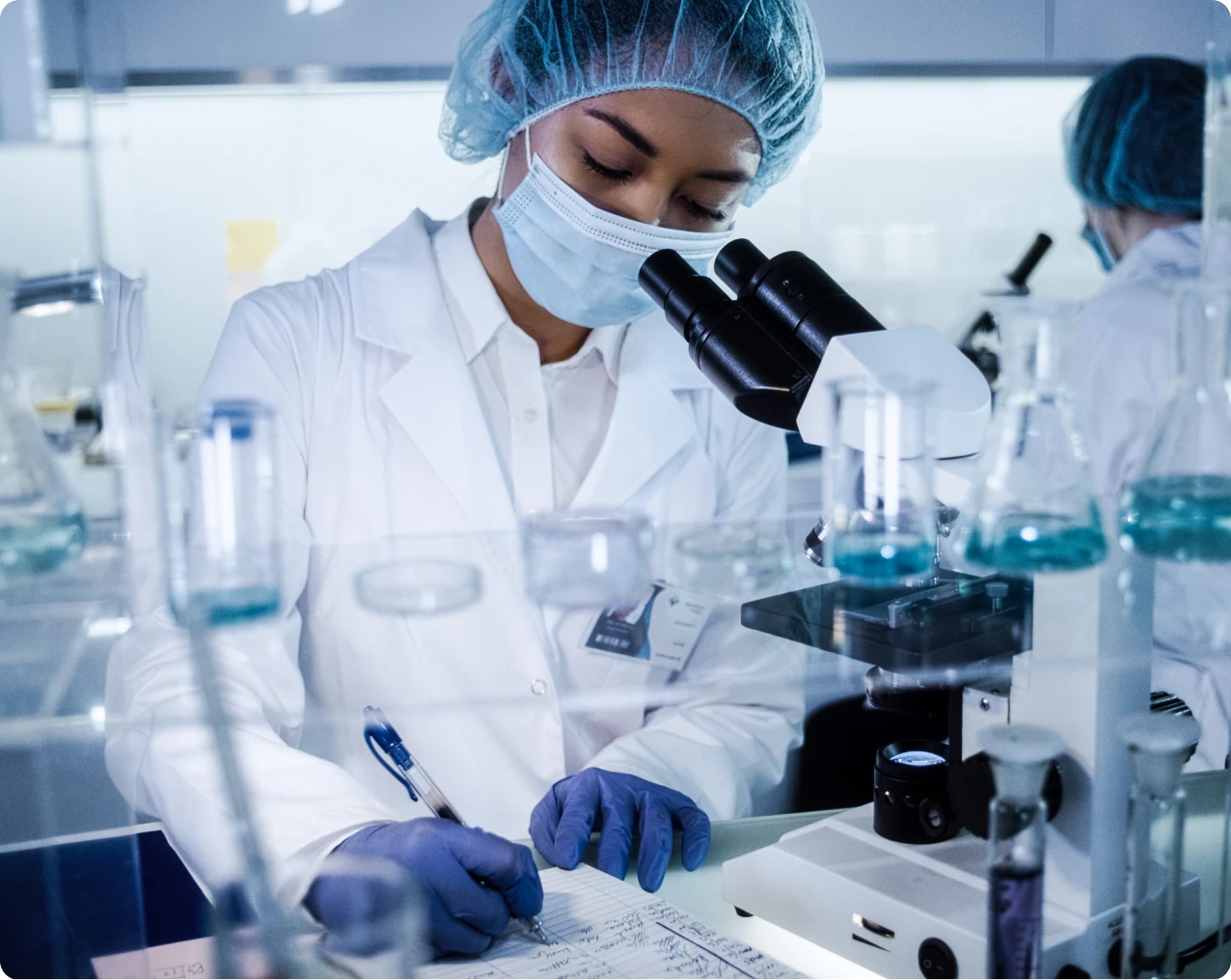Scientist writing notes in laboratory